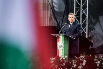 Hungarian Prime Minister Peter Magyar speaking at a 1956 uprising commemoration podium