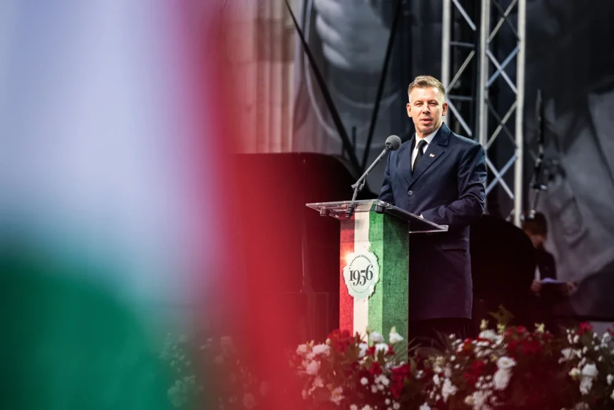 Hungarian Prime Minister Peter Magyar speaking at a 1956 uprising commemoration podium
