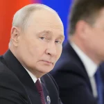 Vladimir Putin looking to the side at an official event