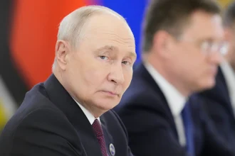 Vladimir Putin looking to the side at an official event
