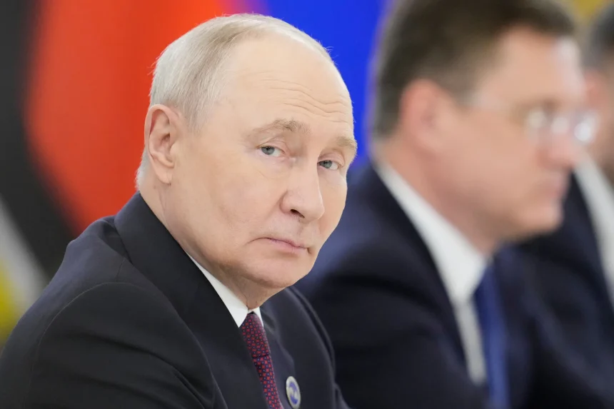 Vladimir Putin looking to the side at an official event