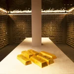 Gold bars displayed inside a secure vault storage facility