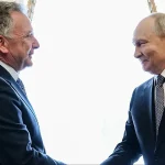 US envoy shakes hands with Russian President Vladimir Putin