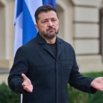 Ukrainian President Volodymyr Zelenskyy gesturing while speaking outdoors